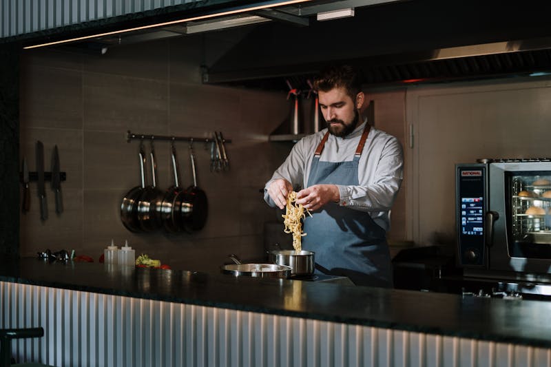 Head chef crafting a pizza at the coal fire station
